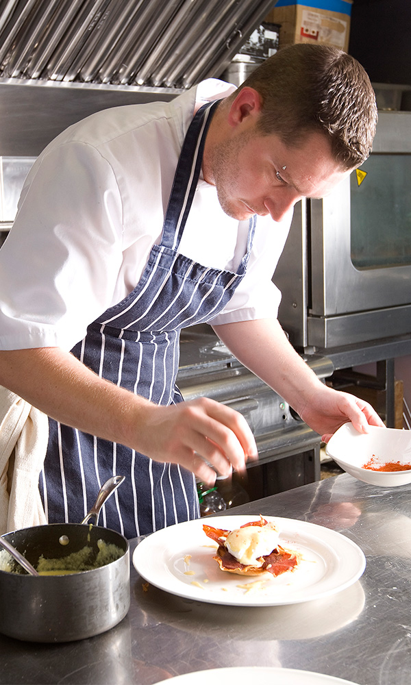 A chef preparing food on the Lord of the Glens cruise ship