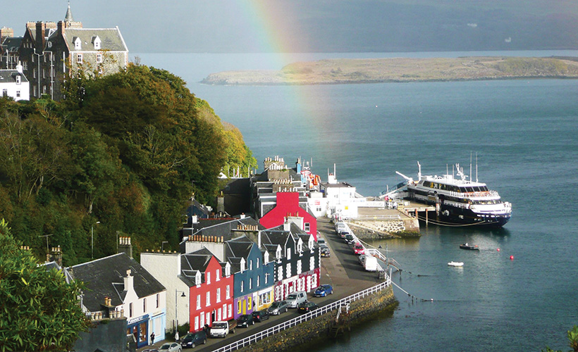 A rainbow over Tobermory with the Lord of the Glens cruise ship docked at the harbour